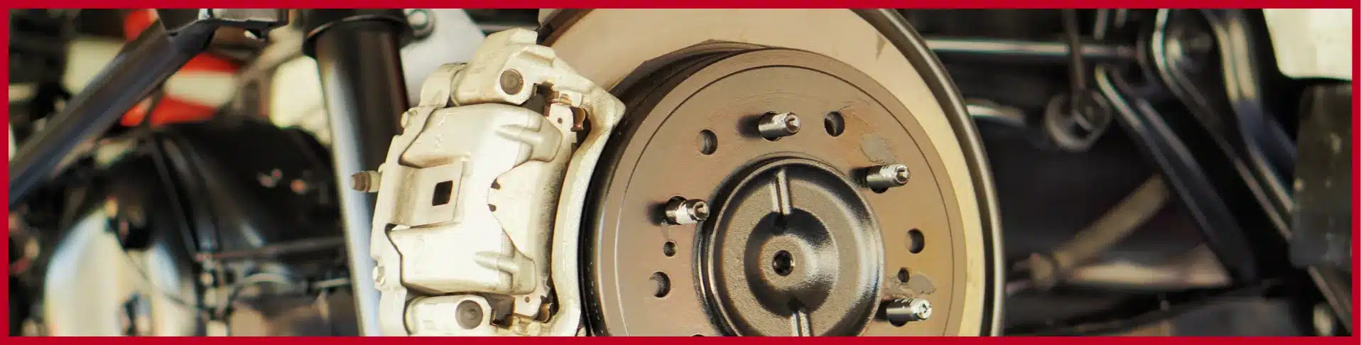 Mechanic inspecting and repairing car brakes at E-Motive Performance Mertztown PA