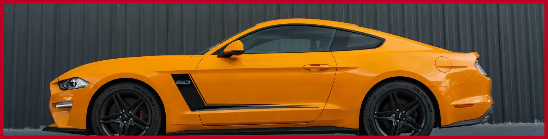 a yellow sports car with black stripes