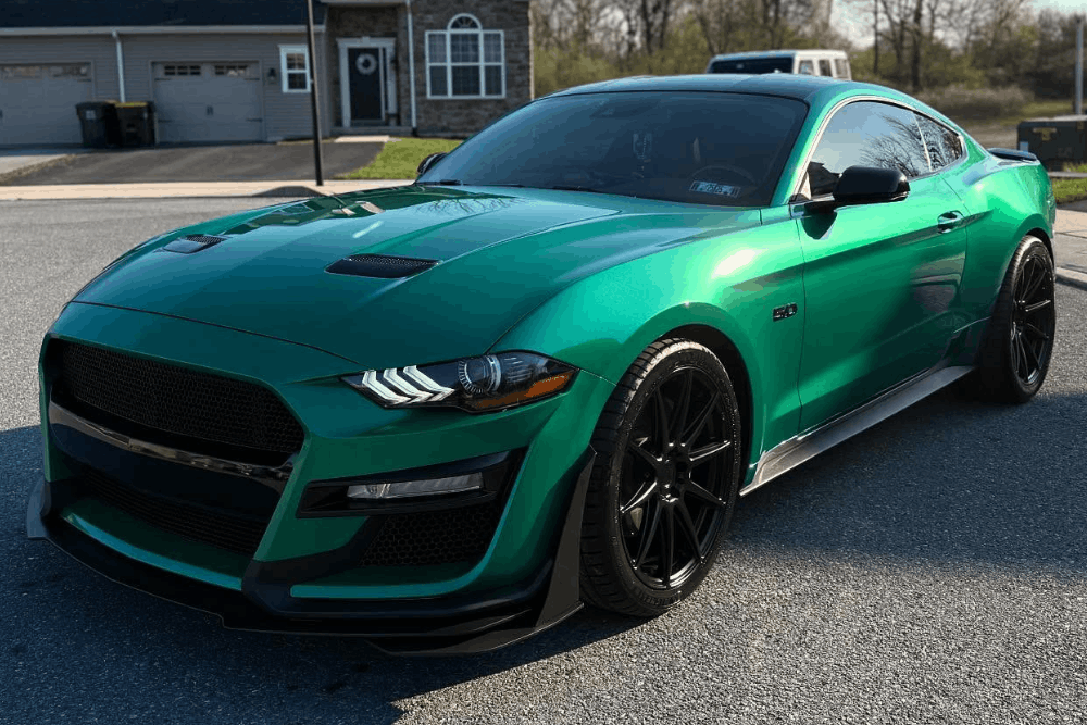 Paint protection film in Mertztown, PA at E-Motive Performance & Auto Repair. Image of a green Ford Mustang with a glossy exterior finish, supporting long-term paint protection and appearance.